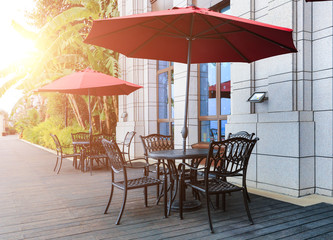 Tables and chairs and umbrellas on the shore of the tropical leisure hotel pool