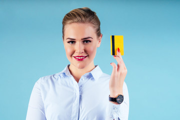 bank employee woman holding golden credit card blue studio portrait.