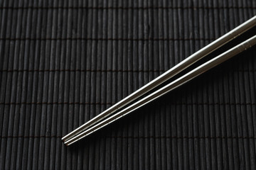 Pair of chopsticks on white background