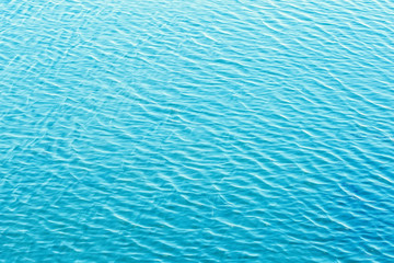 Shining blue wavy water surface ripple background