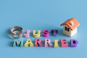 Multicolored inscription just married on a blue background. home