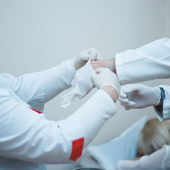 Nurse Assists Surgery.Hands of the surgeon in sterile gloves