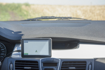 Car with Navigator in the field in the summer
