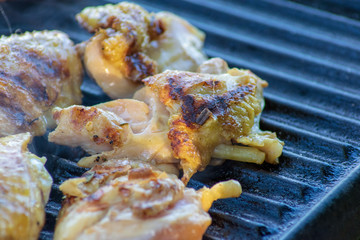 Chicken meat being cooked on the grill 