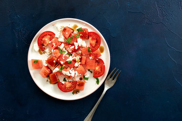 Top view of watermelon salad on blue background
