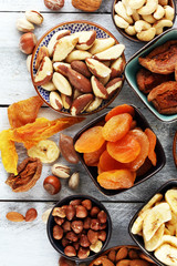 dried fruits and assorted nuts composition on rustic table