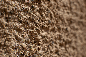 Rough decorative concrete background. Macro. Blurred texture of the concrete coating. A rough uneven background of concrete.