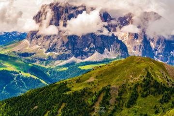 View of the beautiful Dolomites mountain with the clouds floating over the peak