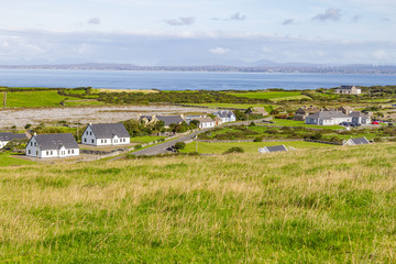 Farms and houses in the Fanore village with Galway bay in background