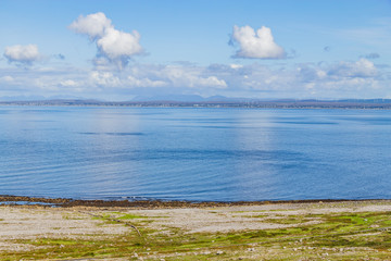 Fanore beach in Burren mountain with Galway bay in background