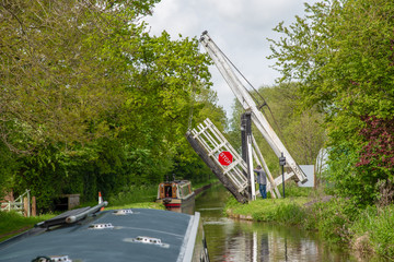 Narrowboat approaches the Wrenbury Frith Lift Bridge No 21 on the LLangollen canal near Wrenbury in...