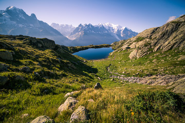 Fototapeta na wymiar Mountain Lake de Chéserys and Iconic Mont-Blanc Snowy Peaks on a Sunny Day.