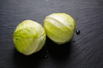 Food concept Organic cabbages on black slate stone board with copy space