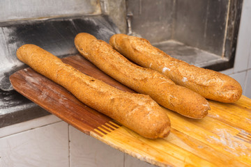 Bread just out from oven. Freshly baked breads, taken out with a shovel.