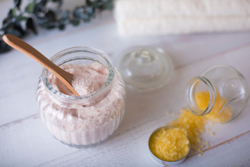 pink and yellow bath salt on white wooden table