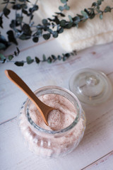 pink bath salt on white wooden table