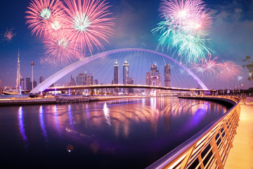 DUBAI, UAE - FEBRUARY 2018: Colorful sunset over Dubai Downtown skyscrapers and the newly built Tolerance bridge as viewed from the Dubai water canal.