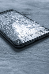 Touch, modern black mobile phone with a broken screen