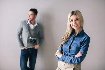 Smiling pretty woman and a man looking away