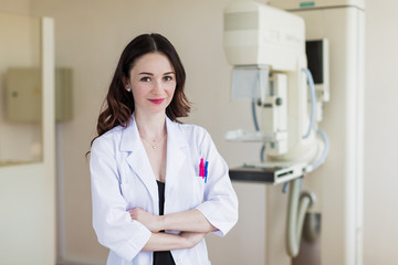 Portrait of the young pretty breast specialist who is standing in her office