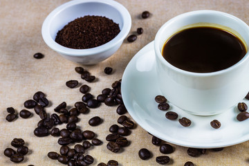 Coffee cup and coffee beans on table
