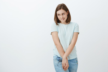 Girl feeling shy standing near love interest. Awkward timid and insecure cute young girl biting...