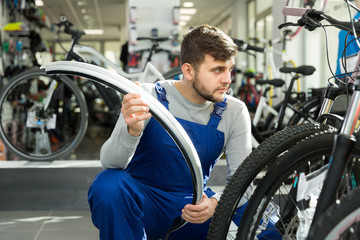 Young professional man holding cycle frame