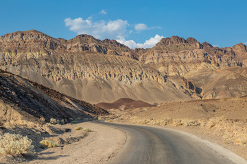 A road in Death Valley, leading towards rugged mountains