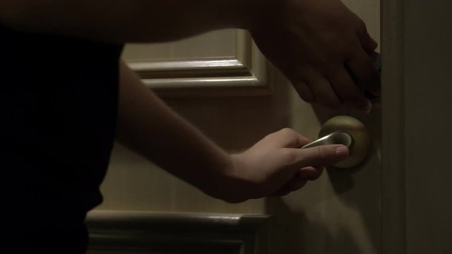 Young Woman Opening Door With Card and Entering Hotel Room