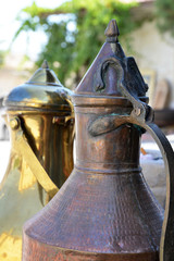 Fototapeta premium Close-up of Traditional Antique Copper and Brass Jugs with Intricate Hand-Hammered Details