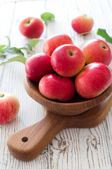 Ripe red apples in wood bowl