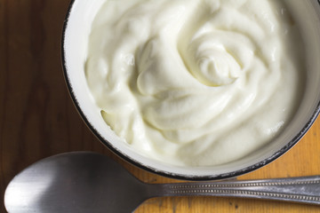 Yogurt in small bowl, natural creamy white greek yoghurt close up - Top view photo