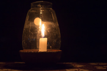 Candle in a Pot Under the Glass