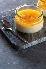 Tropical Passionfruit Panna Cotta, a Creamy Italian Pudding with a Passion Fruit Gelatin Layer, on Granite Cutting Board	