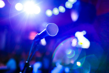 Microphone on stage against a background of auditorium.