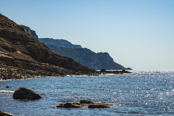Fototapeta na wymiar Alghero, Sardinia Italy - Panoramic view of the Cala Porticciolo gulf with cliffs over the Cala Viola gulf in the Porto Conte Regional Park