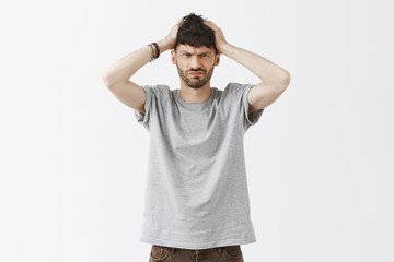 Sober man trying to think, being troubled, focusing on task. Determined good-looking questioned guy...