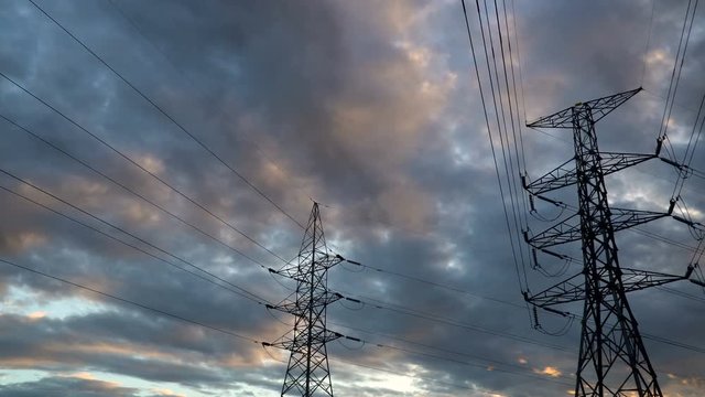 Timelapse silhouette of high voltage electrical pole structure