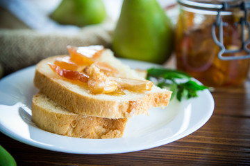 pieces of bread with sweet home-made fruit jam from pears and apples in a plate