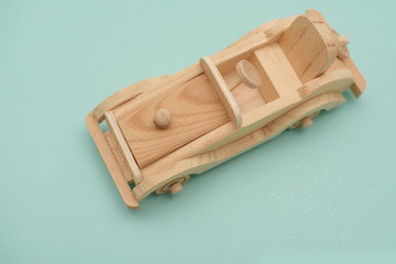wooden toy car on a blue background