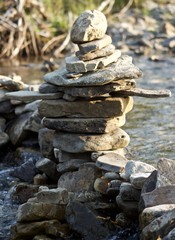 Stone inukshuk along creek dam