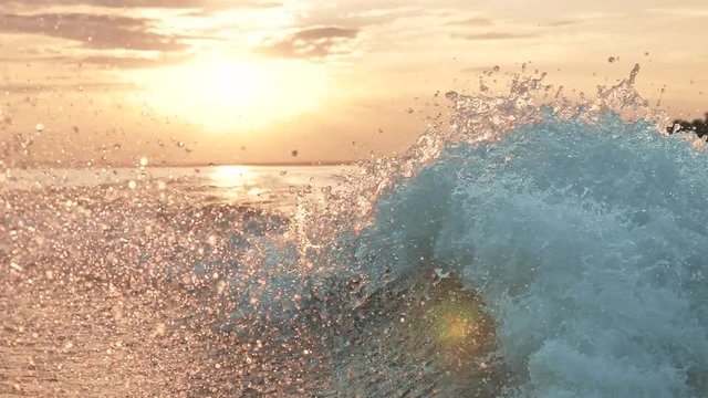 Fast yacht boat wake foam of prop wash at sunset on river