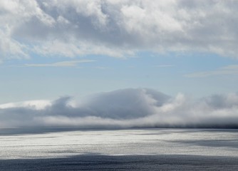 cloud scape with fish shape on the horizon over the ocean 