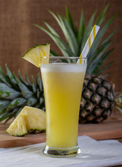 Pineapple smoothies juice on a wooden floor.