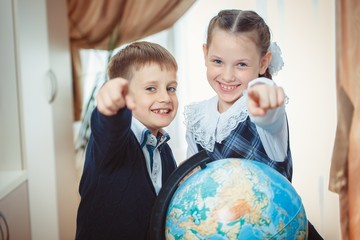 Two students with a globe
