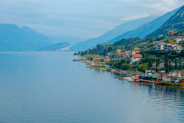 View of lake Garda from the tower in the town of Malcesine. Italy. A view of the tiled roofs of the...