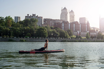 Fototapeta premium SUP Stand up paddle board woman paddle boarding