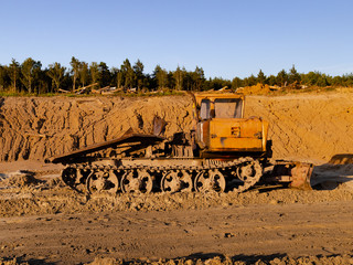 Vintage bulldozer. An abandoned old tractor with on sand quarry. Old tractor in the field