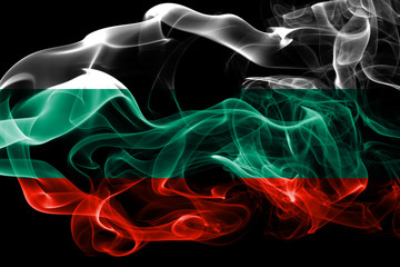 National flag of Bulgaria made from colored smoke isolated on black background. Abstract silky wave background.