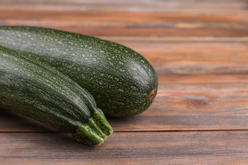 Courgette Black Beauty. Close Up. Brown Wooden Background.